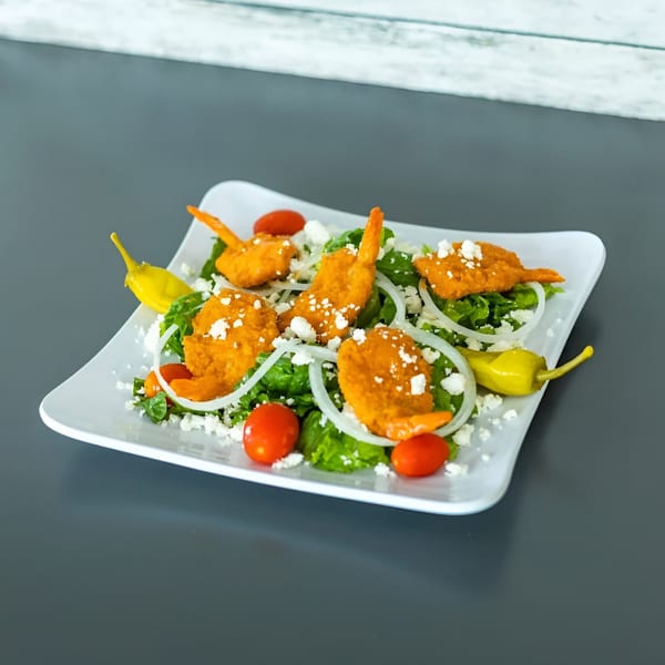 Vittorio's Pizza's buffalo shrimp salad with lettuce, tomatoes, onions, feta, and peppers.